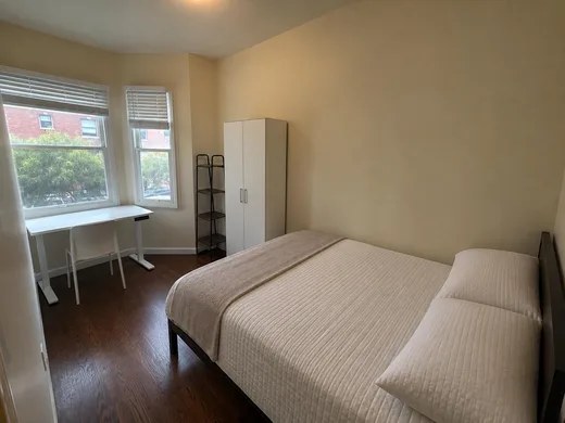 A room in the bay window, looking down a tree-lined street