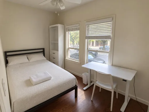 A private room: full-size bed, standing desk and storage