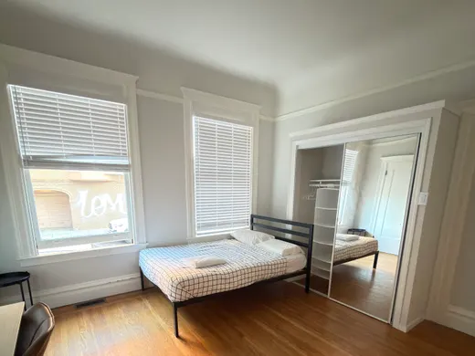 Unit 550: a private room with a full-size bed and a mirrored closet