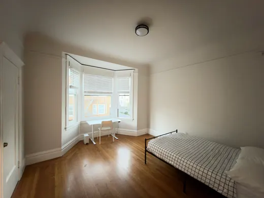 Unit 552: a private room with a standing desk in the bay window