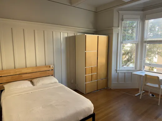 Unit 552: a private room with a wardrobe and a bay window